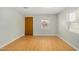 Bright, airy living room with wood-look flooring and a door that compliments the light, neutral walls at 398 W Elgin St, Chandler, AZ 85225