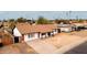 Aerial view of a charming single-story home with a spacious driveway and well-kept desert landscaping at 4052 W Eva St, Phoenix, AZ 85051