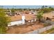 Aerial view of a single-Gathering home showcasing the roof, backyard, and surrounding neighborhood with palm trees at 4052 W Eva St, Phoenix, AZ 85051