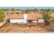 Aerial view of the home highlighting the roof, chimney, backyard, and privacy fence in a residential neighborhood at 4052 W Eva St, Phoenix, AZ 85051