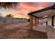 Expansive backyard featuring a covered patio with brick columns and block fence, perfect for outdoor living at 4052 W Eva St, Phoenix, AZ 85051