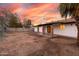 Backyard featuring covered patio with brick columns, showing expansive yard and block fence at 4052 W Eva St, Phoenix, AZ 85051