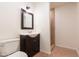 Bathroom with a dark wood vanity, white sink, toilet, and tiled shower at 4052 W Eva St, Phoenix, AZ 85051