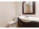 Bathroom with a dark wood vanity, white sink, and toilet at 4052 W Eva St, Phoenix, AZ 85051