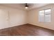 A bedroom with laminate wood floors, a ceiling fan, and a window with blinds at 4052 W Eva St, Phoenix, AZ 85051