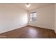 This bedroom features laminate wood floors and a window with blinds at 4052 W Eva St, Phoenix, AZ 85051