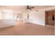 Bright, open living room featuring neutral tile flooring, white walls, and a brick accent wall at 4052 W Eva St, Phoenix, AZ 85051