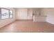 Well-lit room with neutral tile flooring, a window, and built-in cabinets with a serving bar at 4052 W Eva St, Phoenix, AZ 85051