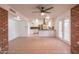 Open concept living room and kitchen, with brick features and tile flooring at 4052 W Eva St, Phoenix, AZ 85051