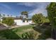 Expansive backyard featuring lush green grass, mature trees, and a sparkling swimming pool at 4307 E Turney Ave, Phoenix, AZ 85018