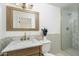 Beautiful bathroom with a custom vanity, framed mirror, and glass-enclosed shower at 4307 E Turney Ave, Phoenix, AZ 85018