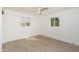 Bright bedroom featuring wood floors, a modern ceiling fan, and natural light from two windows at 4307 E Turney Ave, Phoenix, AZ 85018