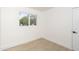 Bright bedroom featuring wood floors, an ensuite bathroom, and natural light from one window at 4307 E Turney Ave, Phoenix, AZ 85018