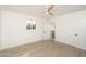 Bright bedroom featuring wood floors, a modern ceiling fan, an ensuite bathroom, and natural light from one window at 4307 E Turney Ave, Phoenix, AZ 85018