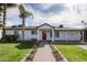 Charming home with red front door, manicured lawn, and lush landscaping at 4307 E Turney Ave, Phoenix, AZ 85018