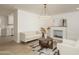 Bright living room with a modern chandelier, fireplace, neutral furniture, and stylish rug at 4307 E Turney Ave, Phoenix, AZ 85018