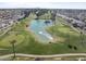 An aerial showcases the golf course community with ponds, mature trees, and lush landscaping, ideal for outdoor enthusiasts at 4662 E Escondido Ave, Mesa, AZ 85206