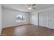 Neutral bedroom featuring a round window, closet doors, and wood-look floors at 4662 E Escondido Ave, Mesa, AZ 85206