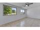 Spacious bedroom with tiled floors, natural light, and a ceiling fan at 4662 E Escondido Ave, Mesa, AZ 85206