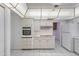 Well-lit kitchen with white cabinets, a built-in oven, and tile flooring at 4662 E Escondido Ave, Mesa, AZ 85206