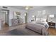 Serene main bedroom featuring a ceiling fan, hardwood floors, and an en-suite bathroom at 4662 E Escondido Ave, Mesa, AZ 85206