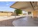 A covered patio offers a tranquil outdoor space with desert landscaping, great for relaxation and enjoying the serene backyard at 4662 E Escondido Ave, Mesa, AZ 85206