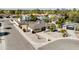 A sunny aerial view of a charming single-story home with a well-kept gravel yard, and palm trees at 4702 E Monte Cristo Ave, Phoenix, AZ 85032