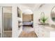 Bathroom featuring a double sink vanity, arched doorway to bedroom, and walk-in shower at 4702 E Monte Cristo Ave, Phoenix, AZ 85032