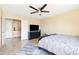 Spacious bedroom featuring a ceiling fan, tile flooring, and built-in cabinets for extra storage at 4702 E Monte Cristo Ave, Phoenix, AZ 85032