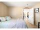 Cozy bedroom with tile flooring, pastel bedding, and an open doorway to another room at 4702 E Monte Cristo Ave, Phoenix, AZ 85032