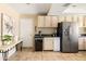 Bright kitchen featuring wooden cabinetry, granite countertops, tile flooring, and stainless steel appliances at 4702 E Monte Cristo Ave, Phoenix, AZ 85032