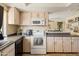 Functional kitchen featuring wooden cabinetry, granite countertops, stainless steel appliances, and tile flooring at 4702 E Monte Cristo Ave, Phoenix, AZ 85032