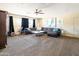 Expansive living room with a large sectional sofa, a ceiling fan, neutral tones, and ample natural light at 4702 E Monte Cristo Ave, Phoenix, AZ 85032