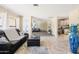 Open-concept living area featuring tiled floors, a modern sofa, and seamless transitions to other rooms in the house at 4702 E Monte Cristo Ave, Phoenix, AZ 85032