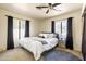 Comfortable main bedroom featuring a ceiling fan, a plush rug, and an abundance of natural light through bright windows at 4702 E Monte Cristo Ave, Phoenix, AZ 85032