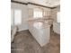 A kitchen with a tile floor, island, shutters, and light-colored cabinets at 4733 E Morning Vista Ln, Cave Creek, AZ 85331