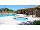Community pool and spa area with lounge chairs, shade structure, and clear blue water for relaxation at 4733 E Morning Vista Ln, Cave Creek, AZ 85331