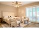 Cozy bedroom featuring neutral tones, a comfortable bed, and natural light from the sliding door at 5100 N Miller Rd # 24, Scottsdale, AZ 85250