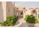 Inviting townhome entrance with a pergola, desert landscaping and address clearly visible at 5100 N Miller Rd # 24, Scottsdale, AZ 85250