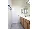 Bathroom with a double sink vanity and tiled floors at 5259 W Village Dr, Glendale, AZ 85308