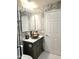 Stylish bathroom featuring a modern vanity with vessel sink and elegant marble-like tiling at 5259 W Village Dr, Glendale, AZ 85308