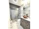 Modern bathroom featuring a glass shower with herringbone tile and stylish vanity with vessel sink at 5259 W Village Dr, Glendale, AZ 85308