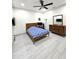 Bedroom with ceiling fan and light gray wood-look tile flooring at 5259 W Village Dr, Glendale, AZ 85308