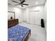 Bedroom with ceiling fan, closet and light gray wood-look tile flooring at 5259 W Village Dr, Glendale, AZ 85308