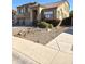 Charming two-story home featuring a three-car garage, tile roof, and desert landscaping at 5259 W Village Dr, Glendale, AZ 85308