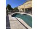 Inviting backyard pool with travertine decking, privacy fence and adjacent covered patio at 5259 W Village Dr, Glendale, AZ 85308