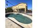 Inviting backyard pool with travertine decking, privacy fence and adjacent covered patio at 5259 W Village Dr, Glendale, AZ 85308