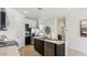 Modern kitchen features stainless steel appliances, dark cabinetry, and a white marble countertop on the center island at 5573 E Rock Bush Ln, San Tan Valley, AZ 85140