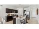 Modern kitchen with stainless steel appliances, dark cabinetry, and a marble countertop island with stool seating at 5573 E Rock Bush Ln, San Tan Valley, AZ 85140