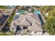 Aerial view of the home's roof with solar panels, stone accents, tile roofing, a patio and a three car garage at 56 S Prairie Rd, Gilbert, AZ 85296